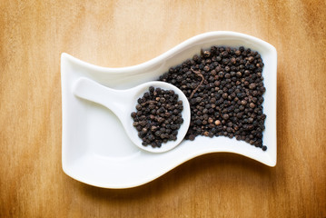 black pepper on wood table
