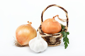 Fresh bulbs of onion in basket on a white background