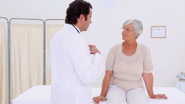 Serious doctor examining a mature woman