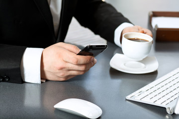 businessman drinking coffee and talking on the phone