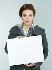Sad woman with white message board