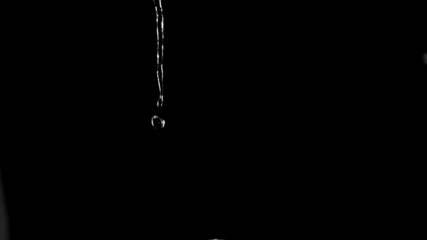 Very thin trickle of water in a super slow motion flowing  - Powered by Adobe