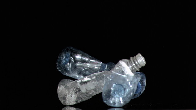 Three plastic bottles in a super slow motion falling - Powered by Adobe