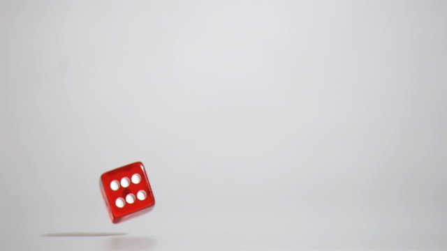 One red dice in a super slow motion rebounding