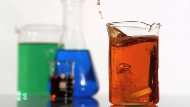 effervescent produit in a super slow motion falling in a red beaker