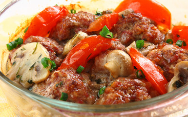 close up meatballs in a glass pen