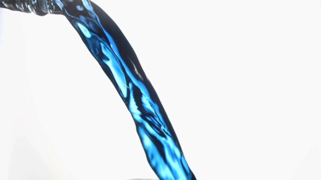 Close up, blue trickle in a super slow motion flowing of the glass bottleneck 