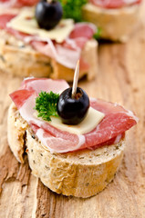 Group of sandwich appetizers with ham and cheese