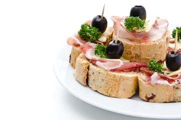 Group of sandwich appetizers with ham and cheese