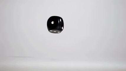 Black dice bouncing in super slow motion - Powered by Adobe