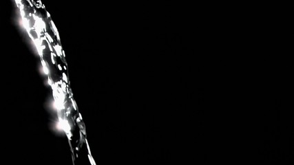 Close up, trickle of water in a super slow motion flowing