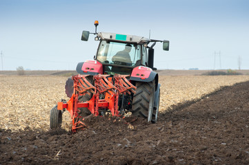 Fototapeta premium Tractor plowing the fields