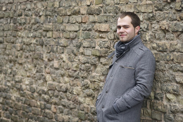Obraz premium Young Man In Gray Coat Smiling