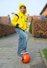 Cute teenage boy with a ball on the street - 40338487