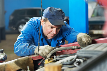 car mechanic diagnosing auto engine problem