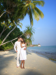 Sensual happy lovers in white clothes on the beach (Maldives)