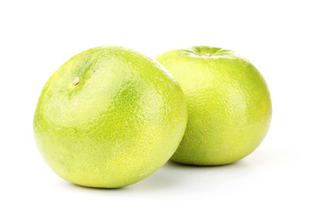 two green grapefruits isolated on white
