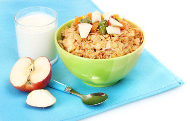 tasty cornflakes in bowl with dried fruits, glass of milk and