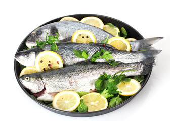 Fresh fishes with lemon, parsley and pepper