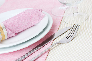 Table setting with fork, knife, plates, and napkin