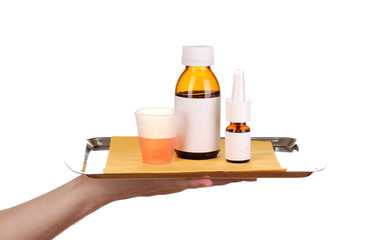 Hand holding tray with medicines isolated on white