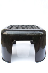 small black plastic chairs  on whitebackground