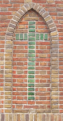 Brick wall with green cross