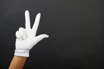 hand of a woman is showing three fingers