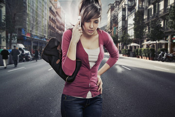 Cute lady speaks by phone on the street