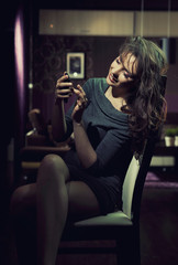 Fototapeta na wymiar Elegant lady using smartphone