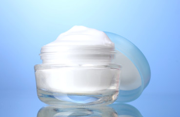 cosmetic cream on blue background