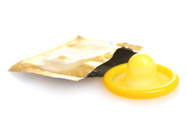 Yellow condom with open pack isolated on white
