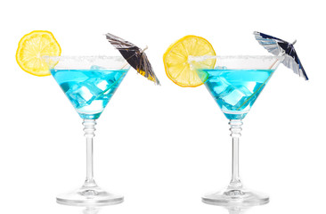 Blue cocktail in martini glasses isolated on white