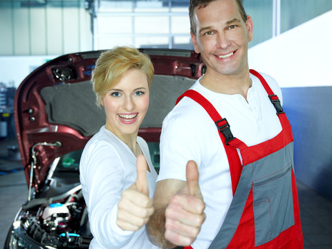 Mechanic and customer show thumbs up for good service
