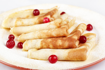 Pancakes with cranberry berries on a plate