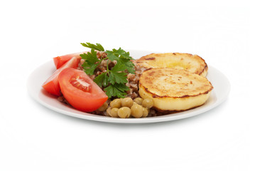 Fried vegetable marrows and buckwheat cereal with tomatoes