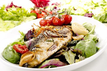 sea bass on a plate with fresh salad