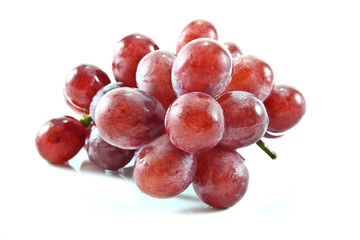 Red grapes on white background.