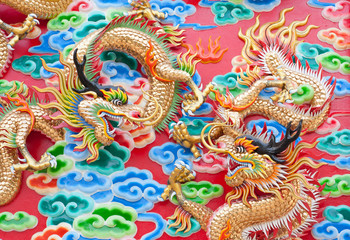 chinese dragon statue  on temple wall in Thailand
