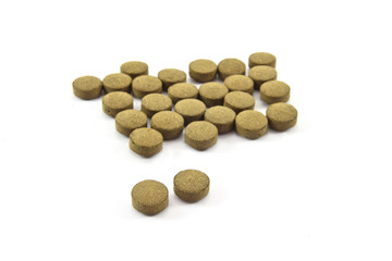 herb pills on white background