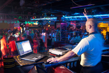 DJ behind the control panel