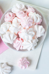 White and pink meringue on a plate