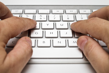 white computer keyboard with hands