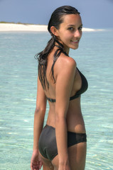 Sensual sexy female bikini model standing in lagoon (Maldives)