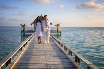 Sensual happy lovers in white clothes on the beach (Maldives)