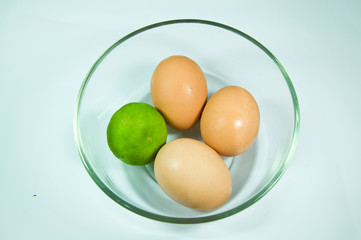 eggs and Lime in cup on a white background