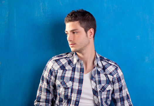 Handsome Young Man With Plaid Shirt On Blue