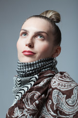 Fashon stylized photo of attractive female dressed in scarf