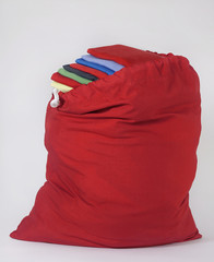 Red Laundry Bag with Folded Colorful Shirts on Top