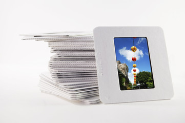 A pile of old slide photos, with a photo of chinese lanterns